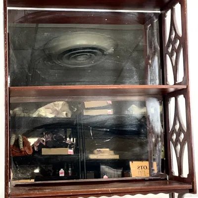 Sale Photo Thumbnail #90: Vintage dark wood wall shelf featuring a mirrored back, scalloped trim, and decorative openwork side panels.