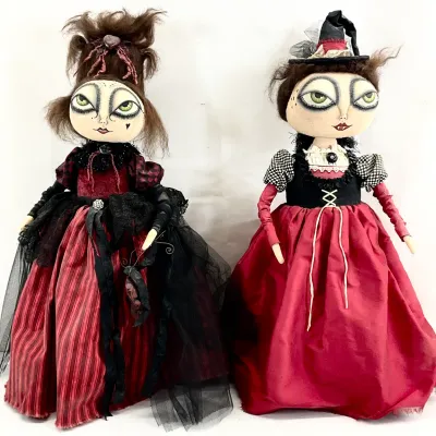 Sale Photo Thumbnail #77: Pair of handmade gothic-style art dolls with large painted eyes, dressed in red and black Victorian-inspired attire.
