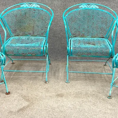 Sale Photo Thumbnail #15: Set of four vintage turquoise-painted wrought iron patio chairs with mesh seats and backs, showing some weathering and rust patina.