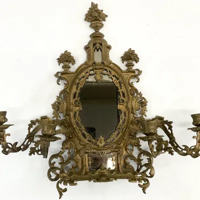 Sale Photo Thumbnail #19: Ornate brass girandole wall mirror featuring a heavily detailed openwork frame with scrollwork, floral finials, and four candle arms.