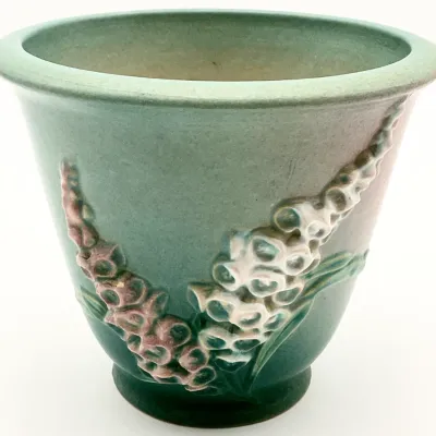 Sale Photo Thumbnail #23: Roseville Pottery Foxglove pattern green planter, featuring embossed floral details in pink and white, circa 1940s.