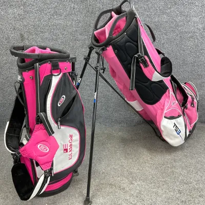 Sale Photo Thumbnail #38: Two pink, black, and white U.S. Kids Golf stand bags, including a TS3 model, showing light wear from use.
