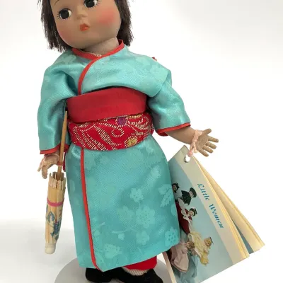 Sale Photo Thumbnail #45: Madame Alexander "Little Women" series doll dressed in a traditional turquoise and red kimono, holding a miniature parasol and featuring the original booklet tag.