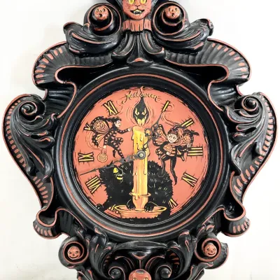 Sale Photo Thumbnail #71: Vintage-style Halloween wall clock featuring an ornate black frame adorned with cat and pumpkin details, surrounding an orange face illustrated with spooky characters.