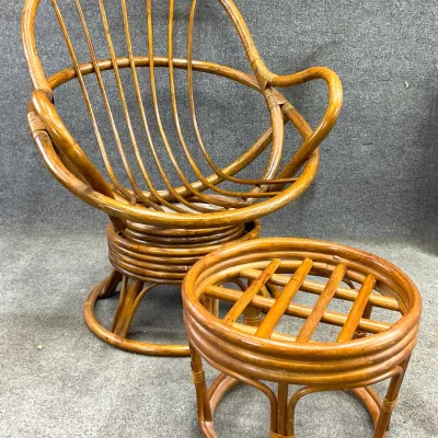 Sale Photo Thumbnail #27: Vintage mid-century modern bamboo and rattan swivel chair with matching round footstool, featuring a curved spindle back design.