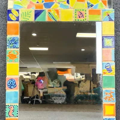 Sale Photo Thumbnail #88: Arched wall mirror featuring a colorful mosaic tile frame with beach and ocean-themed motifs, including a crab, seahorse, and sand dollar.