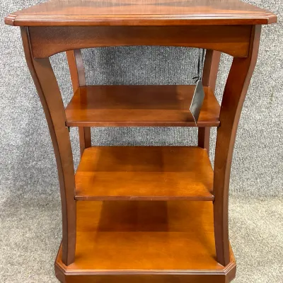 Sale Photo Thumbnail #33: Contemporary cherry-finished wood side table featuring a rectangular top with a decorative veneer pattern, curved legs, and three open shelves.