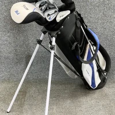 Sale Photo Thumbnail #39: Maxfli golf bag with stand, containing a set of Maxfli Rev3 golf clubs including a driver, fairway wood, and irons.
