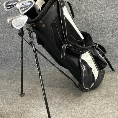Sale Photo Thumbnail #40: U.S. Kids Golf TS3 stand bag in black and white, containing a selection of TS3 Tour Series junior golf clubs.