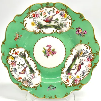 Sale Photo Thumbnail #100: Antique porcelain cabinet plate featuring a scalloped gold-gilded rim, a mint green border, and hand-painted floral and bird vignettes in the Chelsea style.