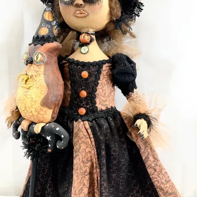 Sale Photo Thumbnail #54: Handcrafted primitive-style Halloween witch doll featuring a detailed fabric face, lace-trimmed dress, and a matching fabric owl companion.