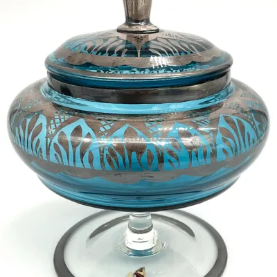 Sale Photo Thumbnail #65: Vintage turquoise glass candy dish with silver overlay, featuring an ornate Art Deco style pattern and matching lid.