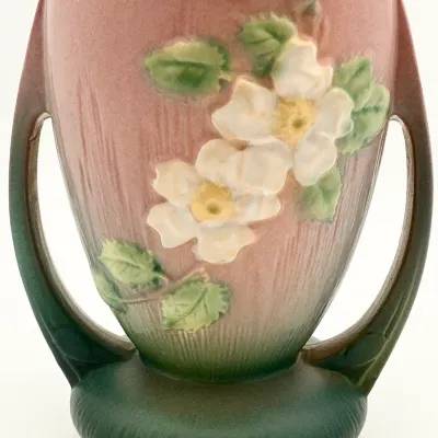 Sale Photo Thumbnail #18: Roseville Pottery Clematis double-handled vase in pink and green, featuring embossed white blossoms and green leaves, circa 1940s.