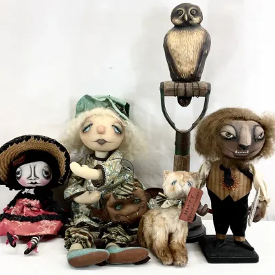Sale Photo Thumbnail #3: Collection of whimsical, handmade Halloween-themed art dolls and figurines, including a witch, a werewolf, a cat, a small doll in a straw hat, and a carved owl on a shovel handle.