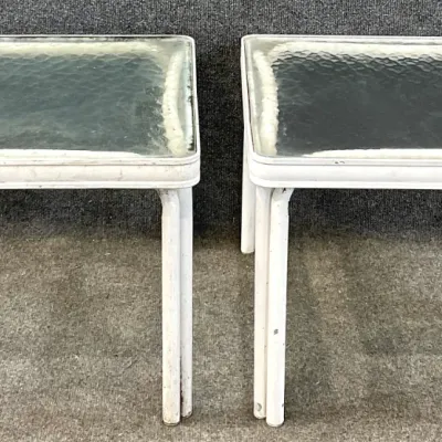 Sale Photo Thumbnail #37: Pair of vintage white metal patio side tables featuring square textured glass tops and double-tubular legs.