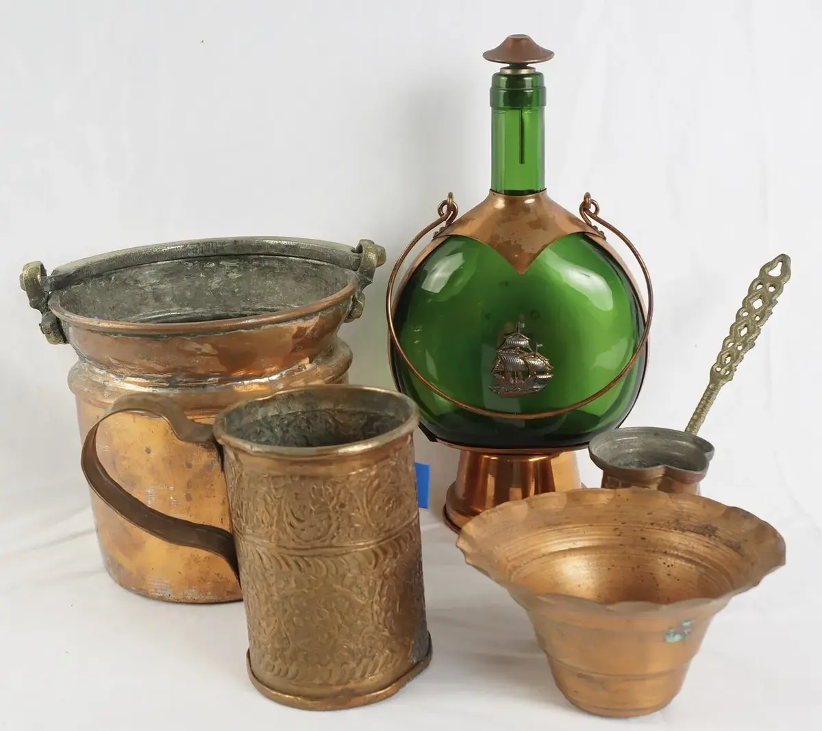 5 Copper Decor Pieces With A Green Glass Musical Bottle In Copper Cradle