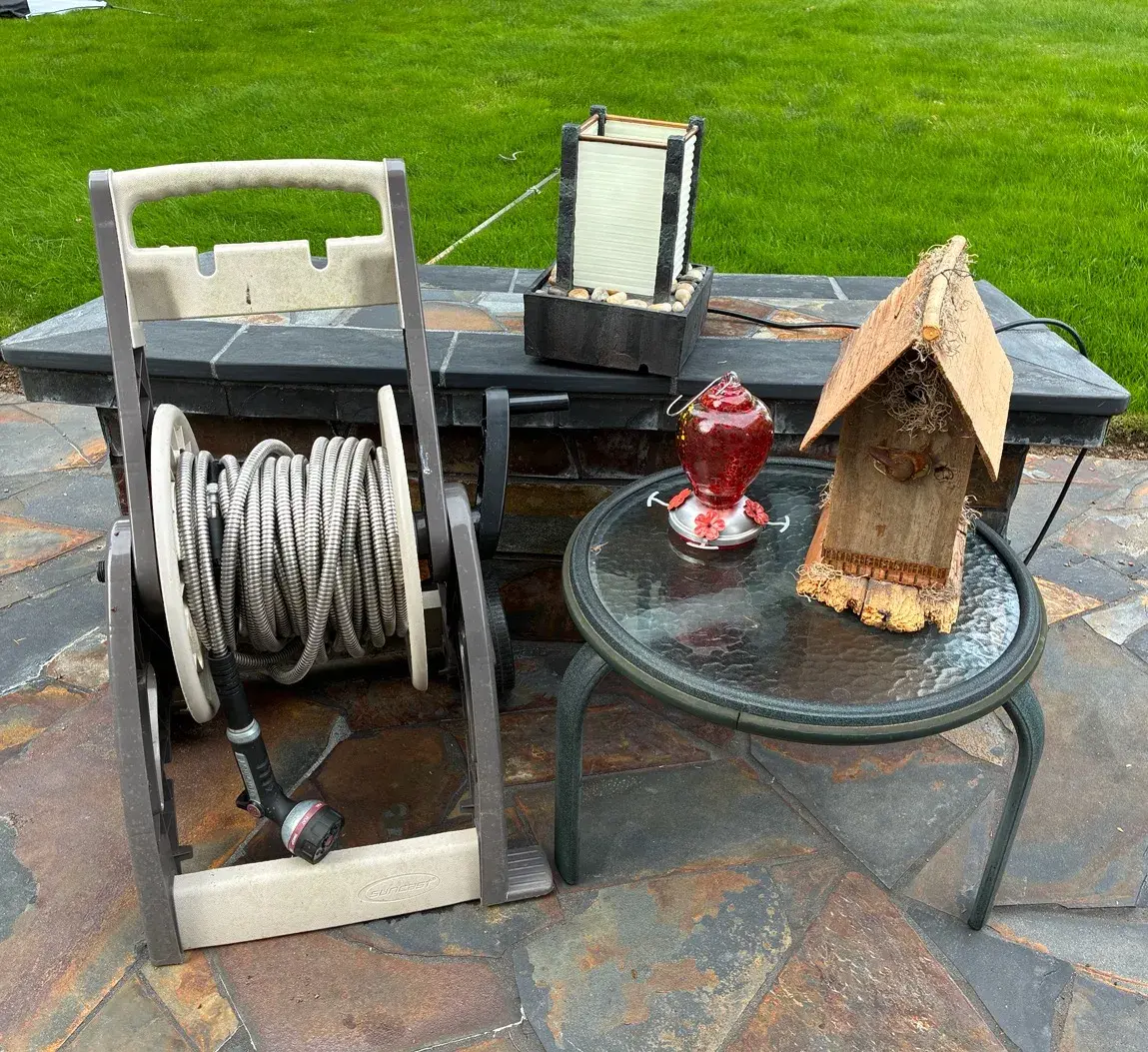 Coiled Metal Garden Hose And Bird House 