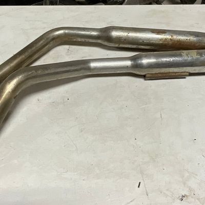 A Pair of Vintage Chrome Tapered Motorcycle Exhaust Header and Muffler Pipes