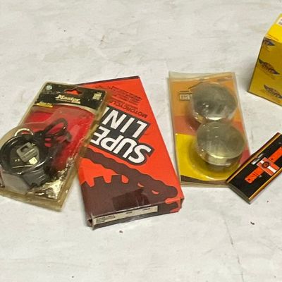 An Assortment of Vintage Motorcycle Replacement Parts and Accessories