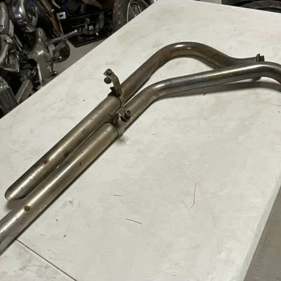 A Pair of Staggered Dual Chrome Finish Motorcycle Exhaust Pipes