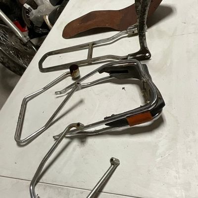 A Group of Chrome-Plated and Steel Motorcycle Accessories Including a Solo Seat Pan and Sissy Bar