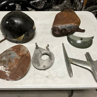 A Collection of Vintage Motorcycle Parts and Accessories Including Helmet and Seat Pan