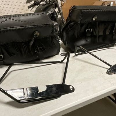 A Pair of Studded Black Leather Motorcycle Saddlebags with Mounting Brackets