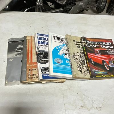 A Collection of Harley-Davidson Service Manuals and a Chevrolet GMC Truck Parts Catalog
