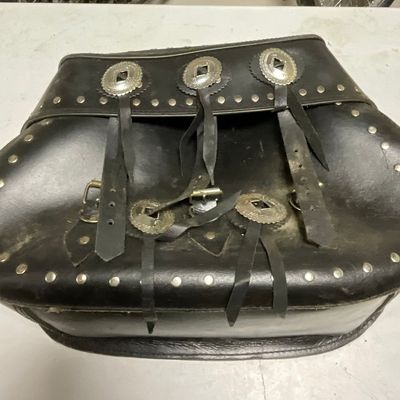 A Single Studded Black Leather Motorcycle Saddlebag with Concho Details