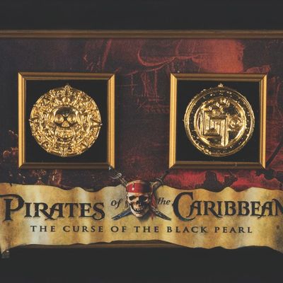 A Framed Pair of "Pirates of the Caribbean" Prop Coins.
