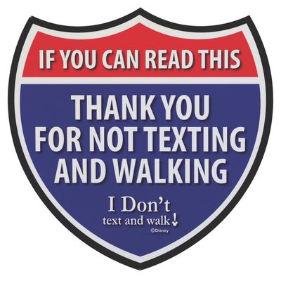 An "I Don't Text and Walk" Backstage Cast Member Sign.