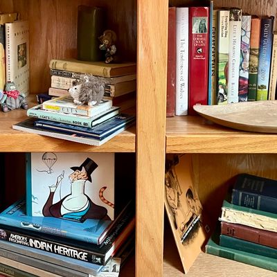 A collection of vintage and modern books, including art history, religious texts, and children's literature, displayed on wooden...