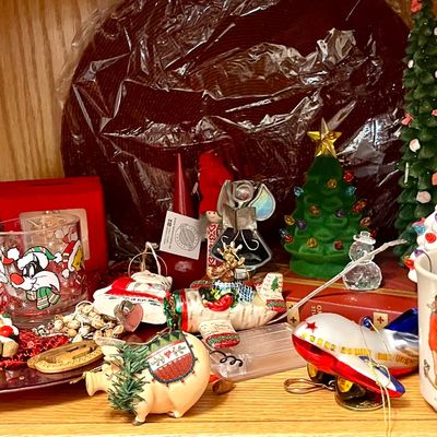 Assortment of vintage Christmas decorations and collectibles, including a Sylvester the Cat glass, a Norman Rockwell Santa mug, and...