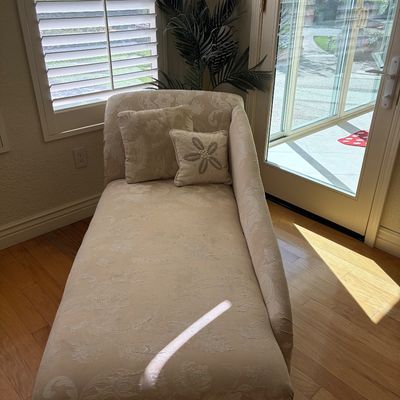 Sale Photo Thumbnail #40: Traditional chaise lounge in a cream-colored floral damask upholstery, featuring a single rolled arm and two coordinating accent pillows.