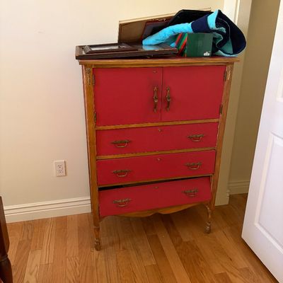 Sale Photo Thumbnail #38: Vintage wooden chifforobe featuring a red painted front with two cabinet doors and three lower drawers, accented by brass hardware.