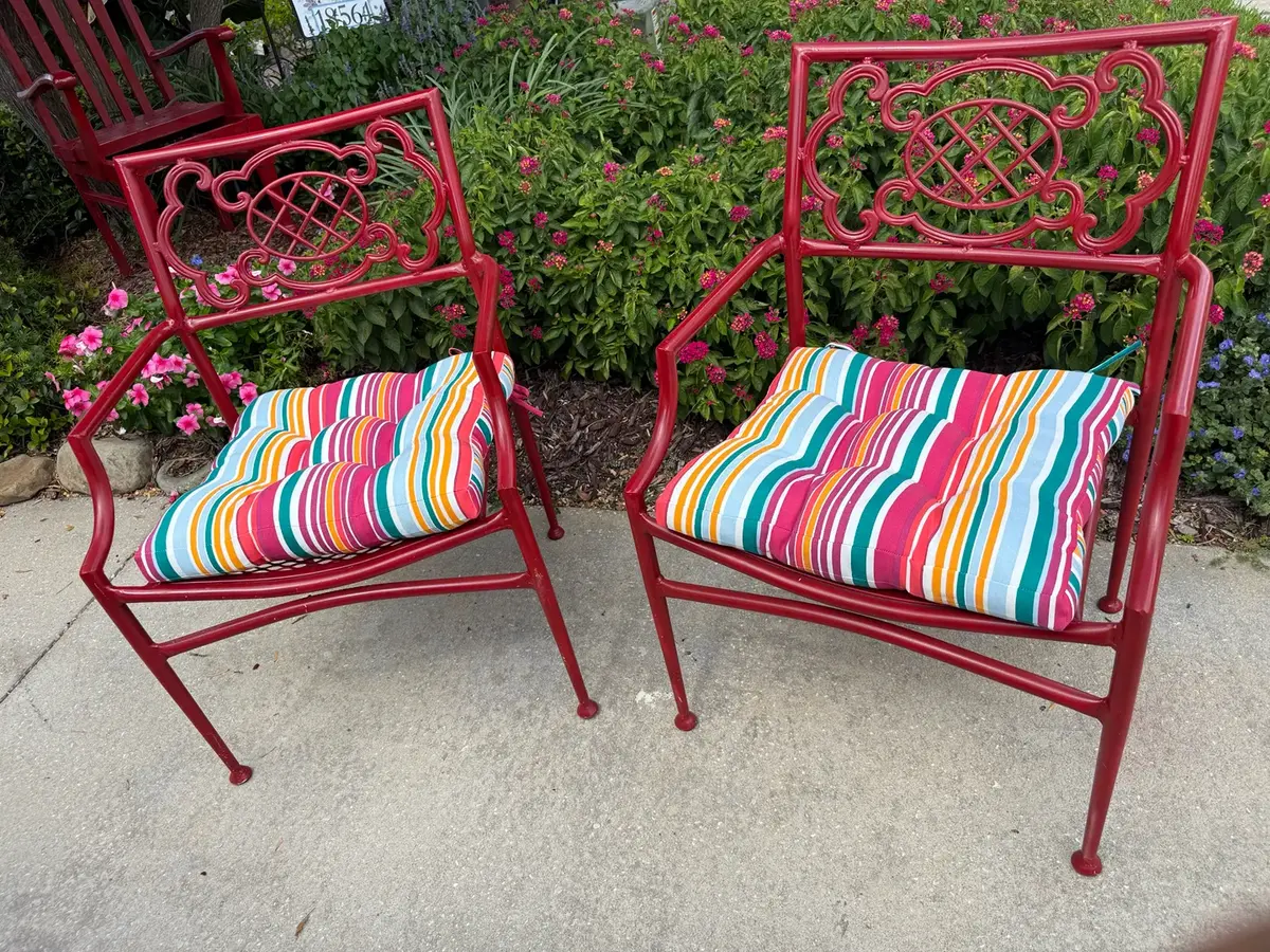 Pair of Ornate Red Cast Aluminum Patio Armchairs with Colorful Cushions