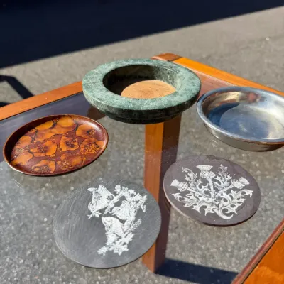 Collection of vintage drink and bottle accessories features distinct mid-century styles