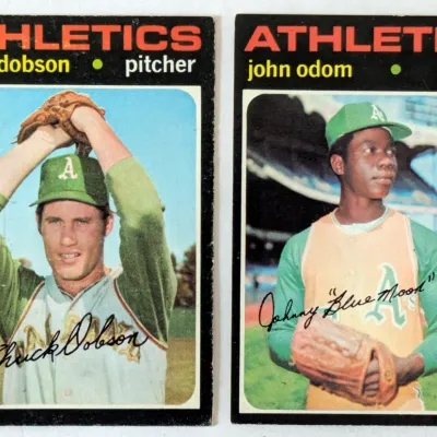 Two 1971 Topps baseball cards featuring Oakland Athletics pitchers Chuck Dobson and John "Blue Moon" Odom, showing some corner...
