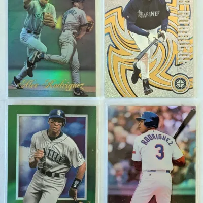 Four Alex Rodriguez baseball cards from his time with the Seattle Mariners, including Topps Gold Label and Pacific Revolution inserts,...