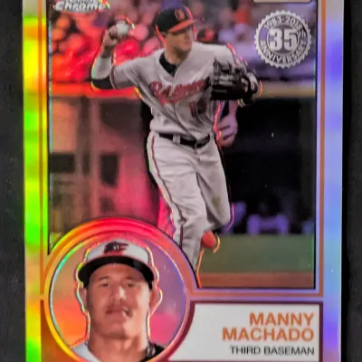 2018 Topps Chrome Manny Machado Baltimore Orioles baseball card, featuring a 35th-anniversary design with a refractor finish.