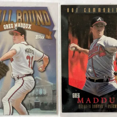 Two Greg Maddux baseball cards, featuring a Topps "Hall Bound" die-cut card and an Upper Deck "Hot Commodities"...