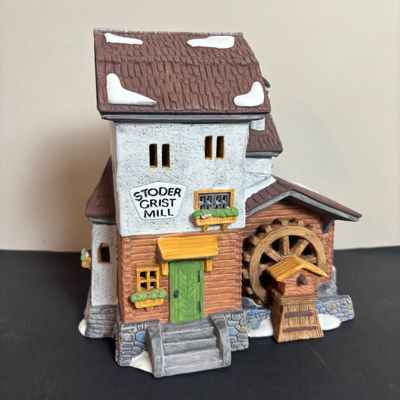 LOT 97: Dept 56 Alpine Village Series: Stoder Grist Mill, Apotek & Tabak along with a Village Porcelain Pine Tree