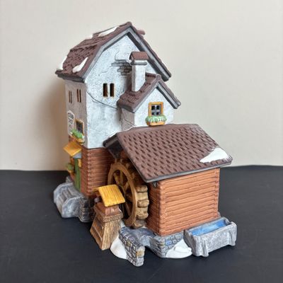LOT 97: Dept 56 Alpine Village Series: Stoder Grist Mill, Apotek & Tabak along with a Village Porcelain Pine Tree