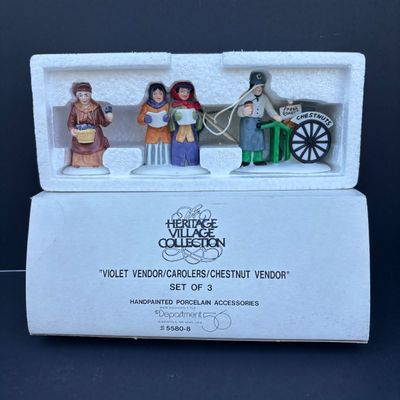 LOT 76: Dept 56 Accessories w/Original Boxes: Sing a Song for Santa, Carolers on the Doorstep, Violet Vendor- Chestnut Vendor-Carolers,...