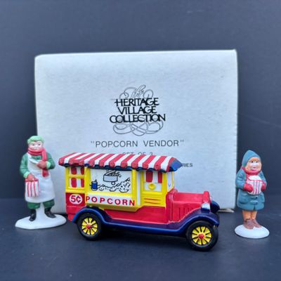 LOT 79: Dept 56 Accessories w/Original Boxes: Popcorn Vendor, Dickens' Carolers, Last Minute Delivery, All Around the Town,...