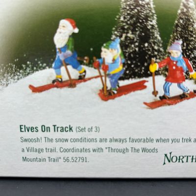 LOT 143: Village Accessories by Dept 56: Delivering Real Plastic Snow, Santa in the City, Elves on Track, Photo w/Santa, Tangles in...