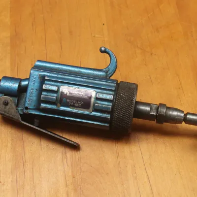 Vintage Central Pneumatic Tool Model No. 25-MC air-powered die grinder with a blue metallic finish, showing some wear from use.