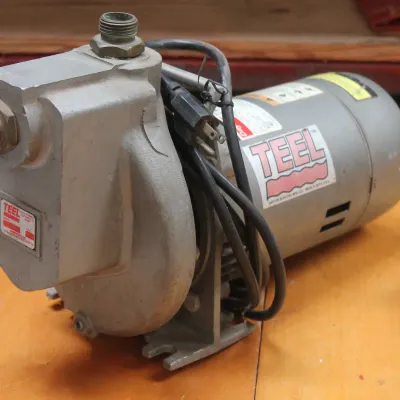 Teel self-priming centrifugal pump with a Dayton electric motor, showing some wear from use.