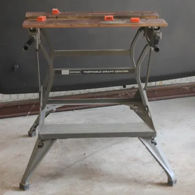 Vintage Craftsman Portable Craft Center folding workbench with a wooden clamping top and orange bench dogs.