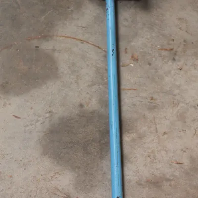 Vintage sledgehammer featuring a light blue painted metal handle and double-faced head, showing signs of wear and use.